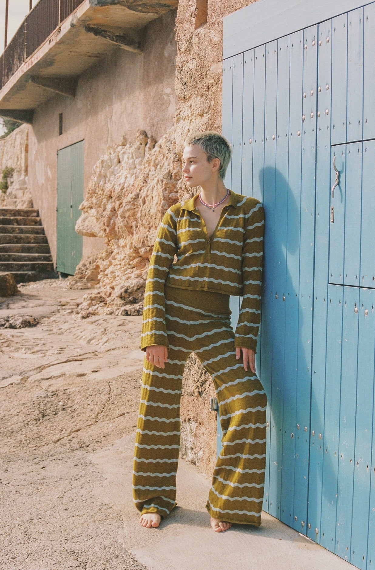 Person wearing a striped yellow and white knit set.