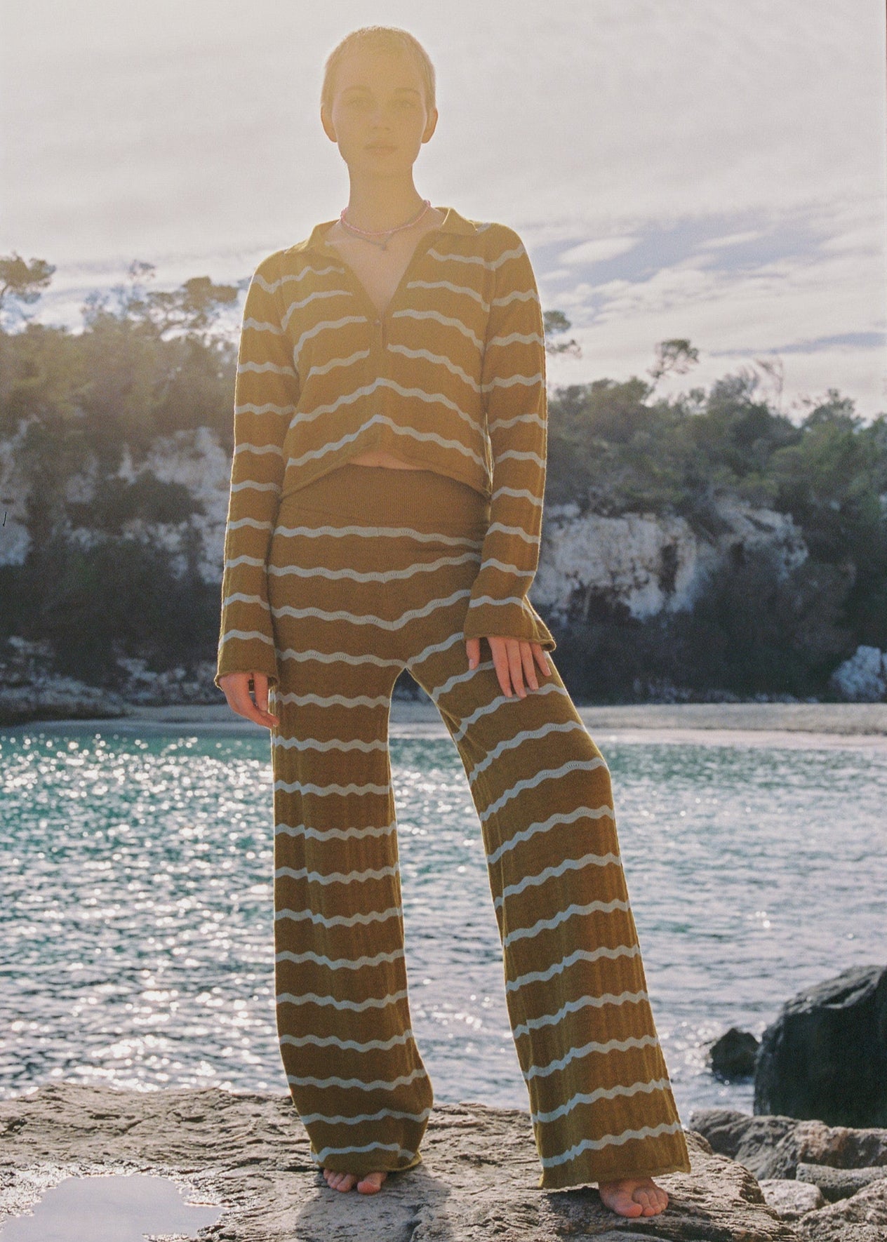 Women wearing a yellow and white matching long sleeve top and long pants set.
