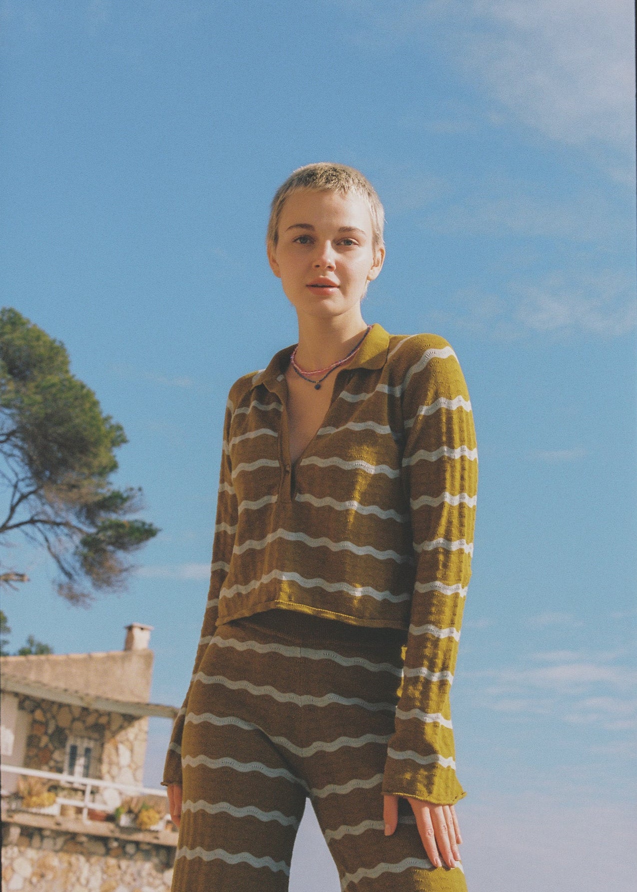 Person wearing a mustard and light blue striped shirt and pant set