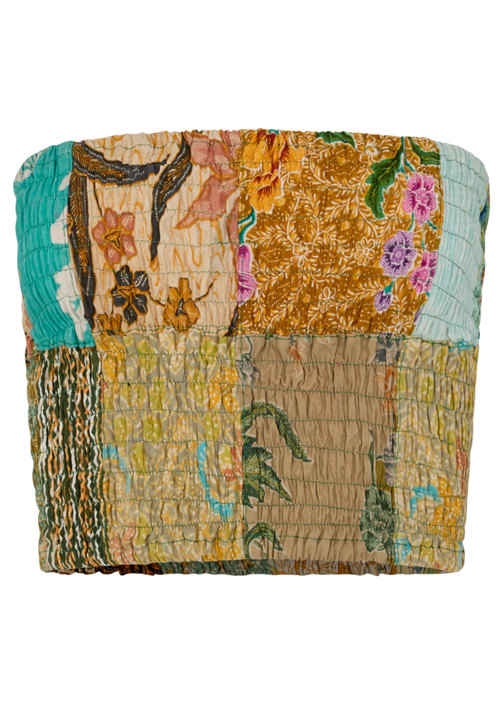 Multicolored patchwork bandeau with floral and abstract patterns on a white background