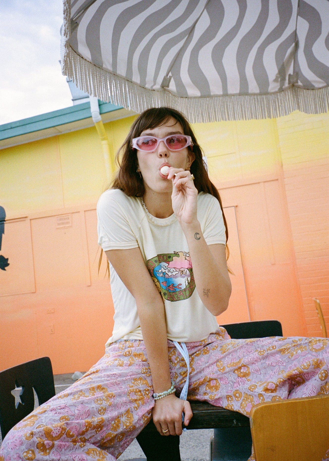 Person wearing wide leg pink patterned pants with blue drawstring 