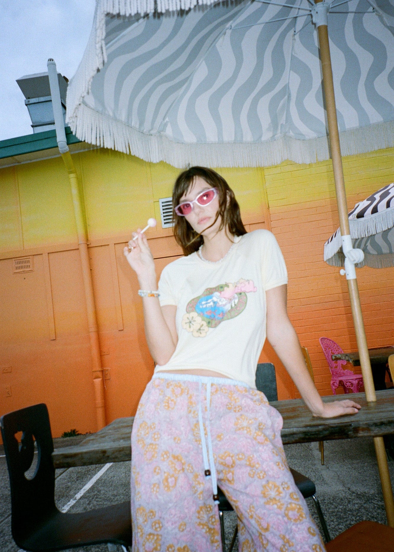 Person wearing wide leg pink patterned pants with blue drawstring 