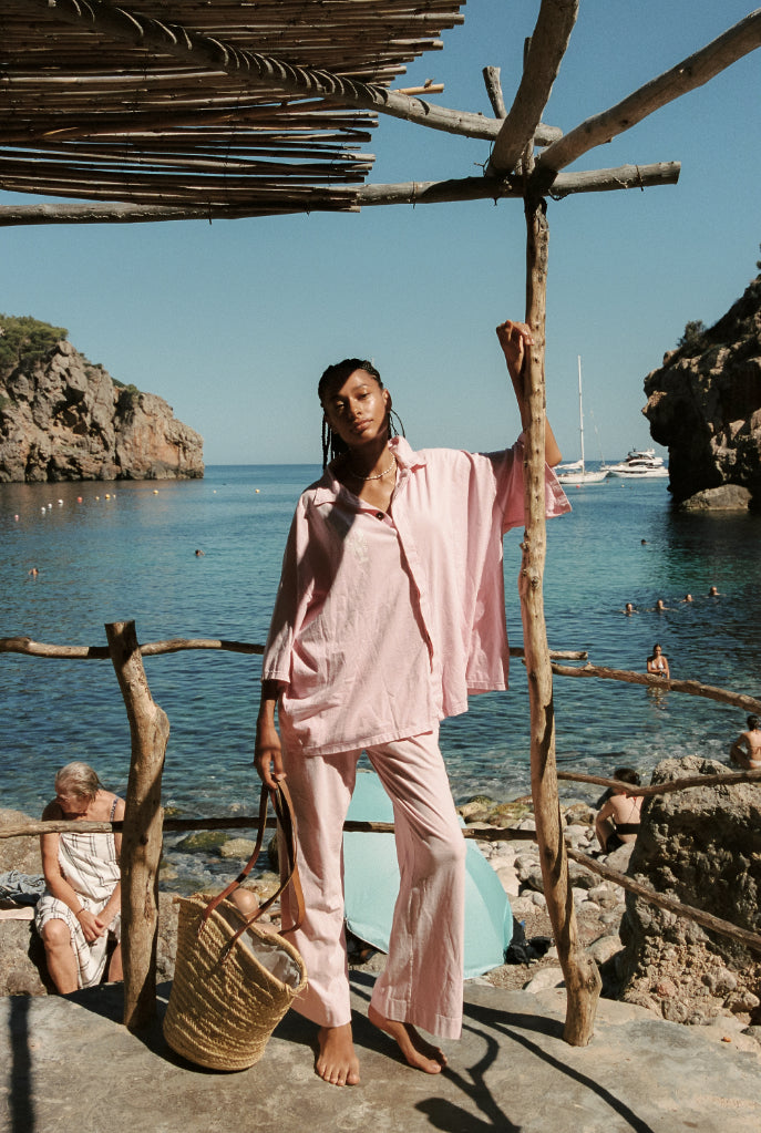 Leize pink oversized matching pink set with button up shirt and loose flowy pants.