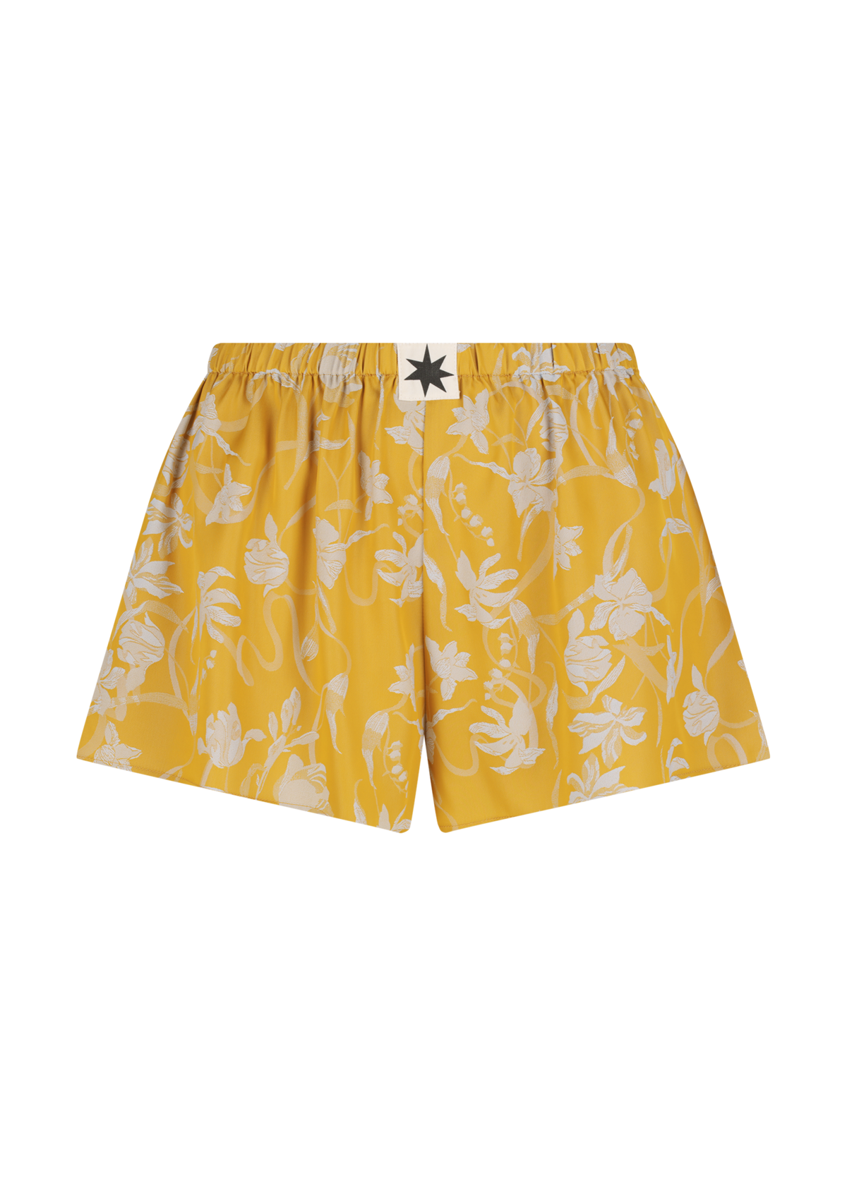 Yellow satin shorts with white floral pattern on a white background
