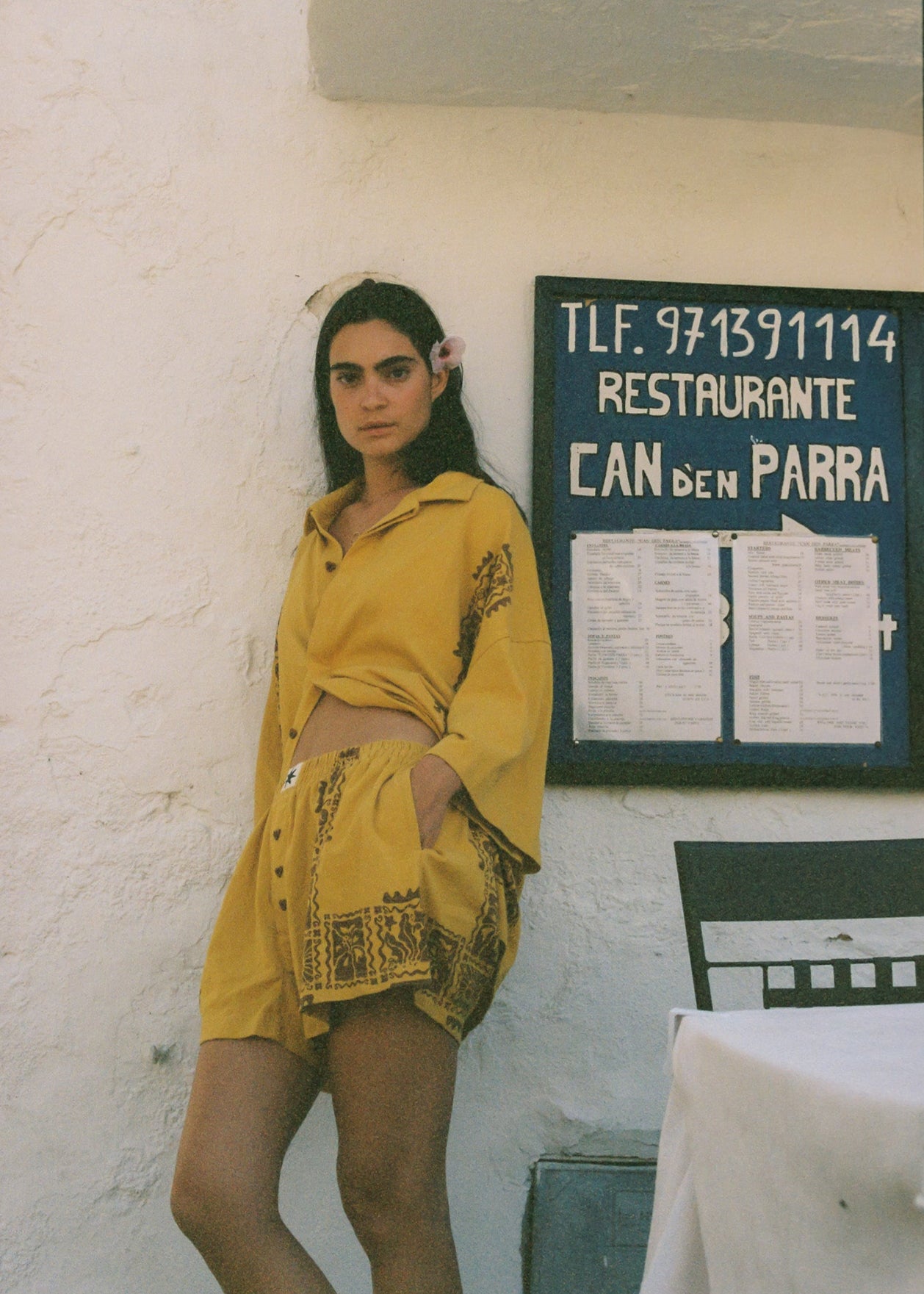 Woman in mustard yellow resort set on vacation