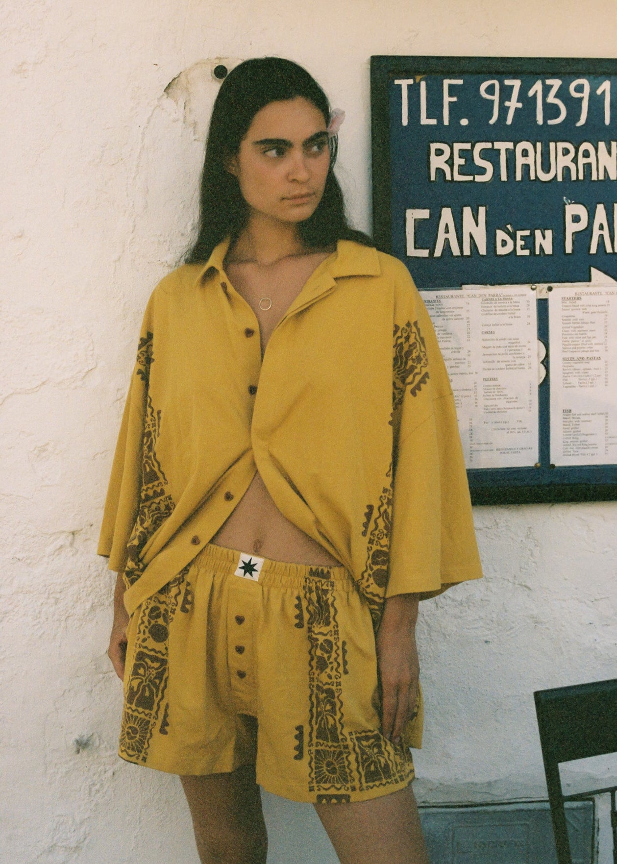 Woman wearing mustard yellow coloured resort set on vacation